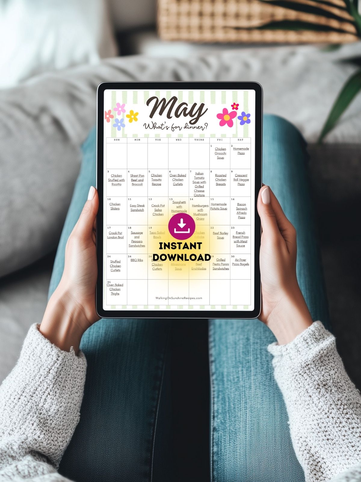 person holding tablet showing May monthly meal calendar with easy dinner ideas.